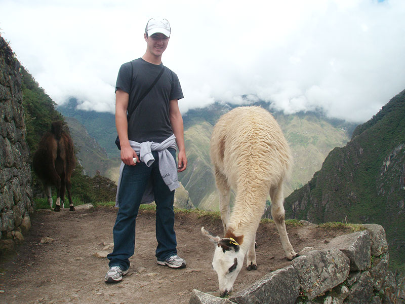 Student with llama, Machu Picchu, Peru